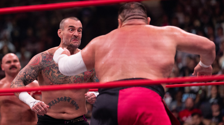 CM Punk makes a face at Samoa Joe