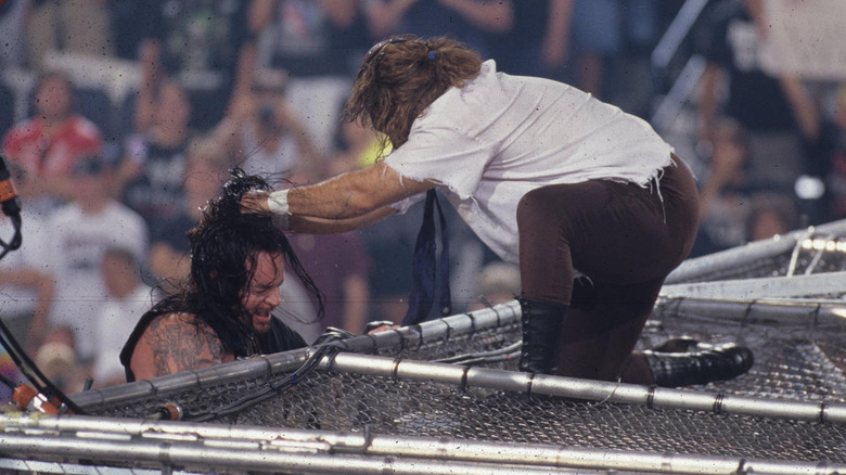Mankind and The Undertaker colliding in a Hell in a Cell match