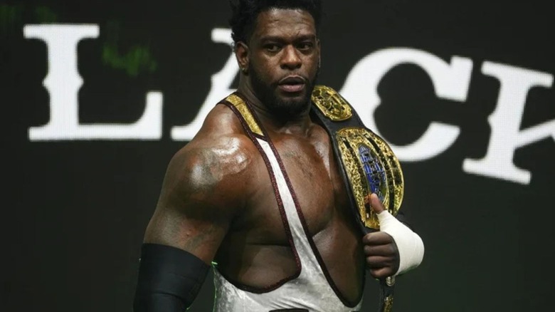 Powerhouse Hobbs makes his way down to the ring, title belt on his shoulder, before a match on AEW programming.