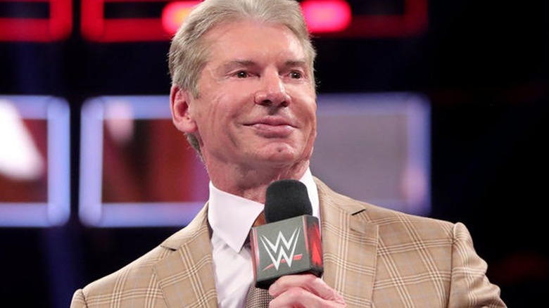 Vince McMahon holds mic