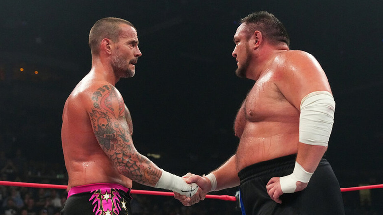 Samoa Joe and CM Punk shake
