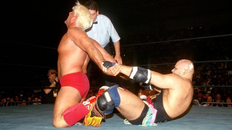 Konnan stretches Ric Flair at WCW Bash at the Beach 1996