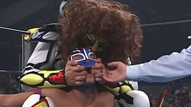 Psicosis claws Rey Mysterio's face at WCW Bash at the Beach 1996