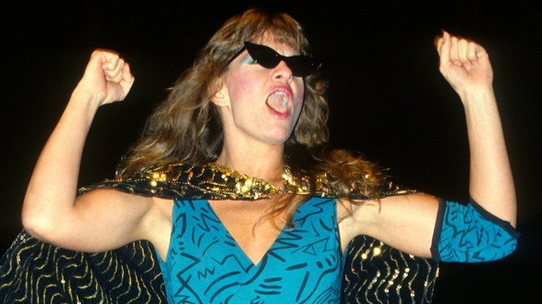 Wendi Richter with arms raised