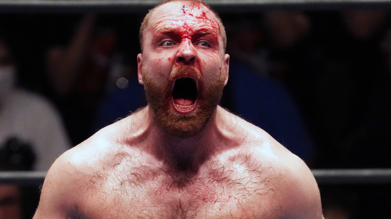 Jon Moxley screaming with blood on his face