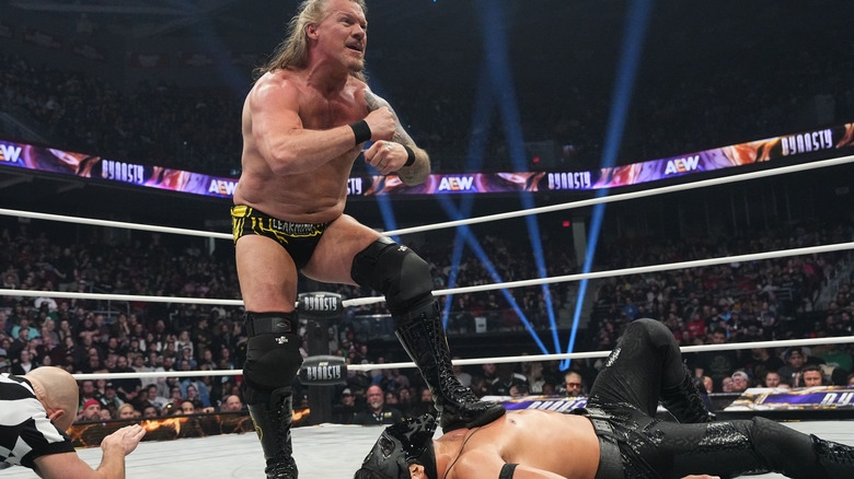 Chris Jericho stands on Bandido's chest as he attempts a pin, and the referee counts, during their match at Dynasty 2025.