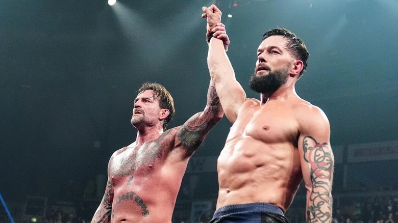 CM Punk raises Finn Balor's arm on "WWE Raw"