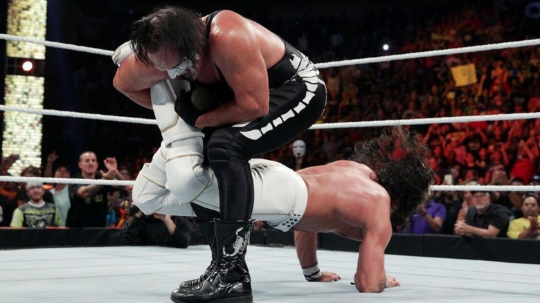 Sting gets World Heavyweight Champion Seth Rollins in a Scorpion Deathlock during their match at Night of Champions in 2015.