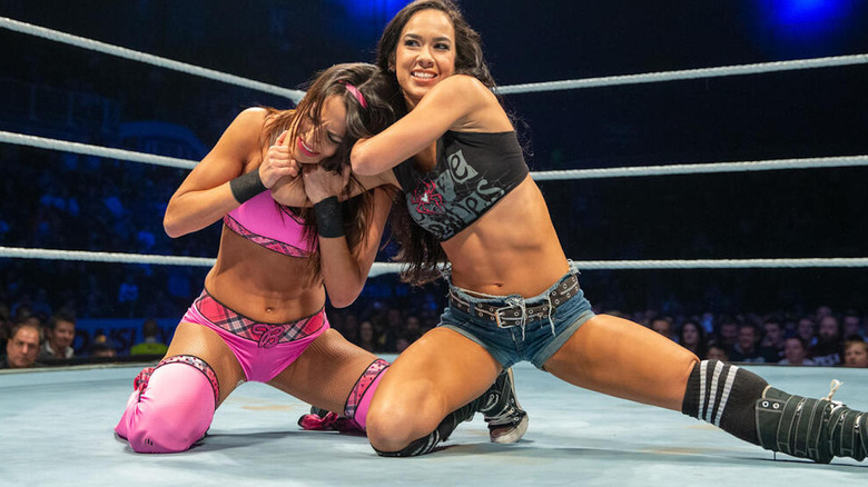 AJ Lee puts Brie Bella in a cravat