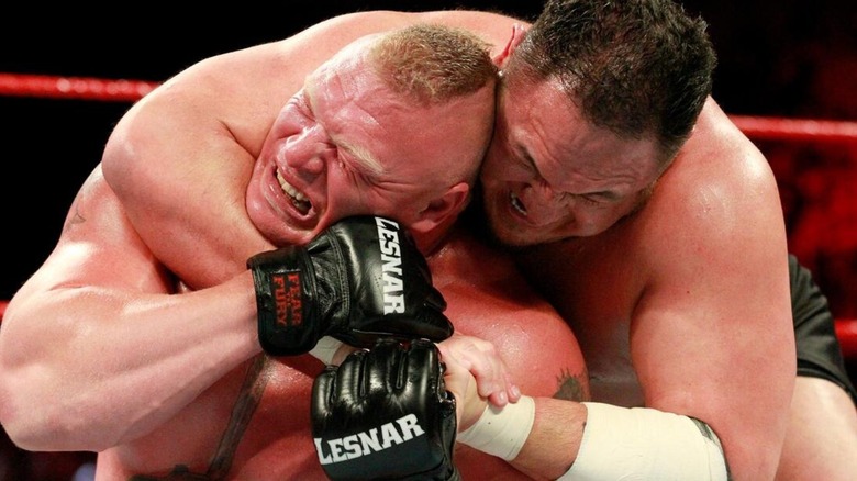 Samoa Joe clutches onto Brock Lesnar
