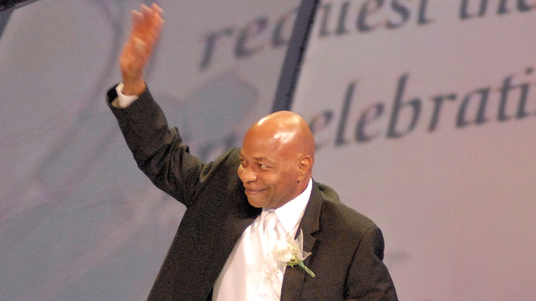 Teddy Long waving