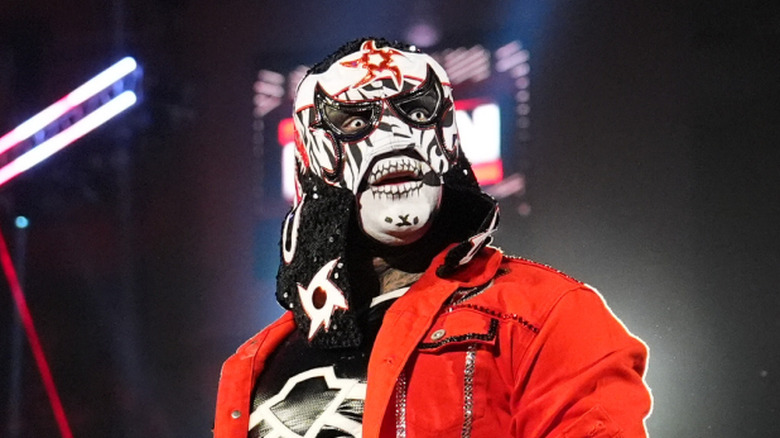 Penta on Raw with a red jacket
