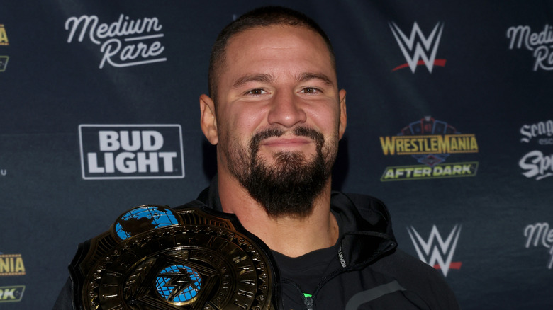 Bron Breakker with the WWE Intercontinental Championship on his shoulder