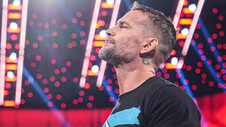 CM Punk standing in a WWE arena