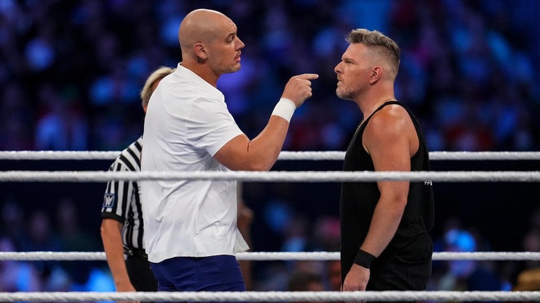 Baron Corbin and Pat McAfee stare at each other