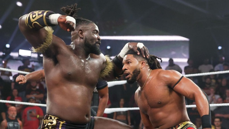Oba Femi hits Trick Williams with a punch in the middle of the ring during a match on 