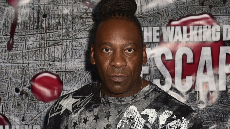 Booker T attempting the bold task of throwing a baseball with one eye closed