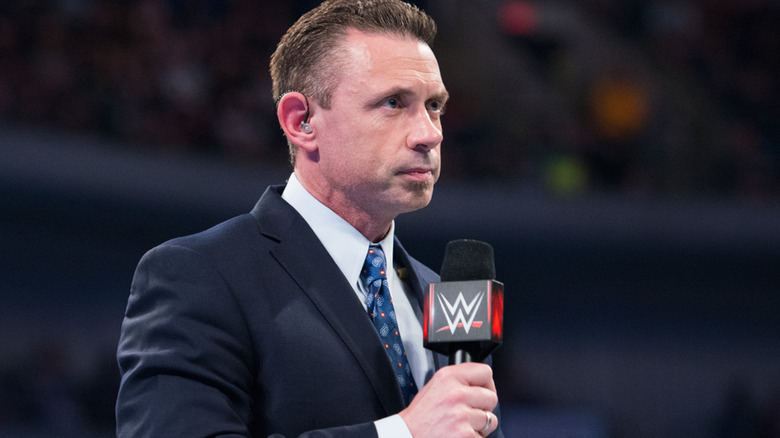 Michael Cole speaks at a WWE event. 