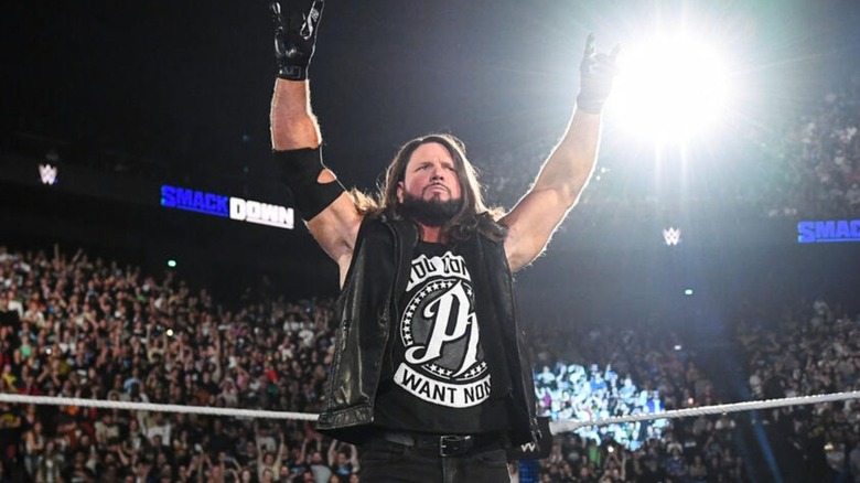 AJ Styles poses in the middle of the ring during a promo segment on 