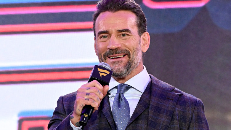 CM Punk is holding a microphone
