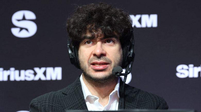 Tony Khan, before the neck brace