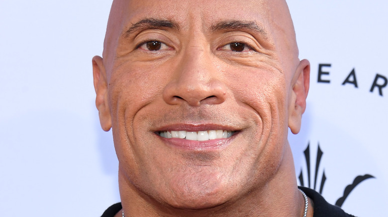 Dwayne Johnson smiling red carpet.