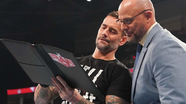 CM Punk signs a new "WWE Raw" contract with Adam Pearce