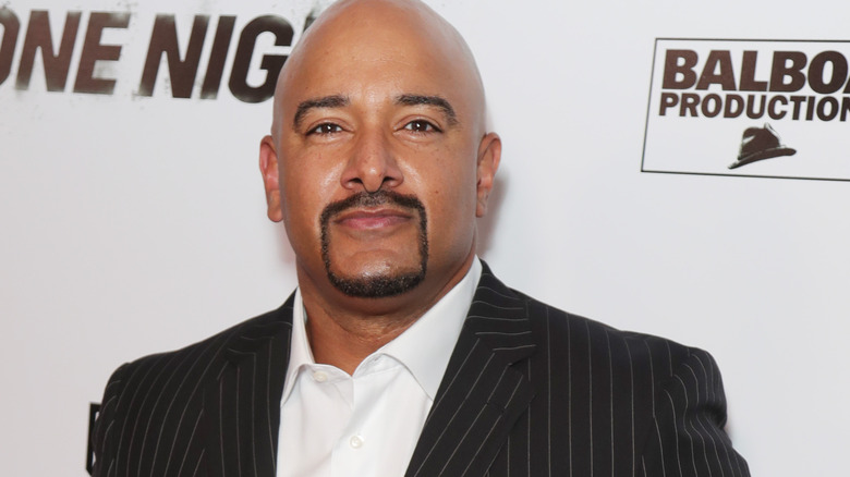 Jonathan Coachman wearing a black striped suit