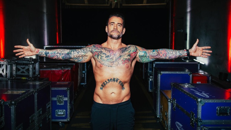 CM Punk shows off his tattoos.