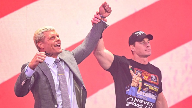 John Cena raises Cody Rhodes' arm