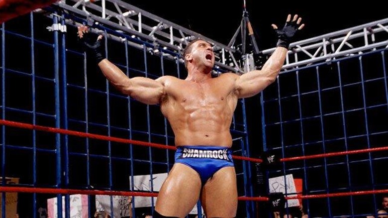Ken Shamrock roars inside of a steel cage.