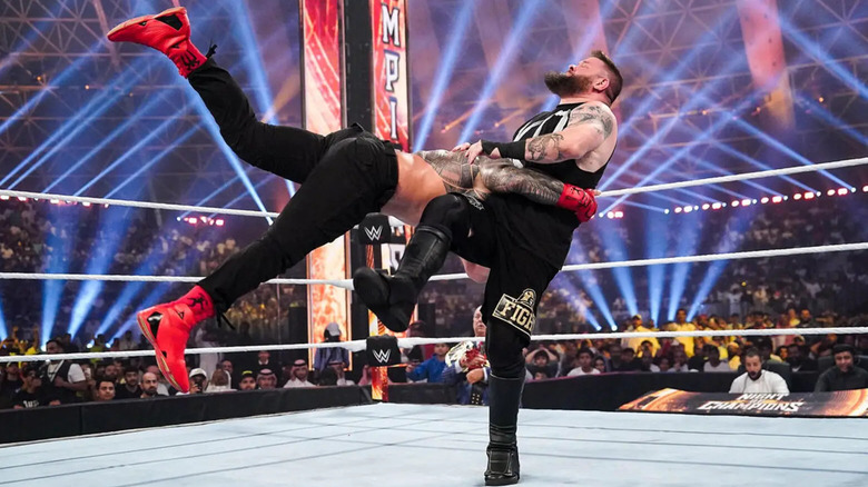 Roman Reigns delivers a spear to Kevin Owens at Night of Champions
