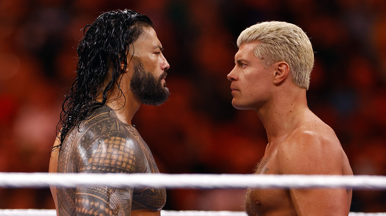 Cody Rhodes facing off with Roman Reigns