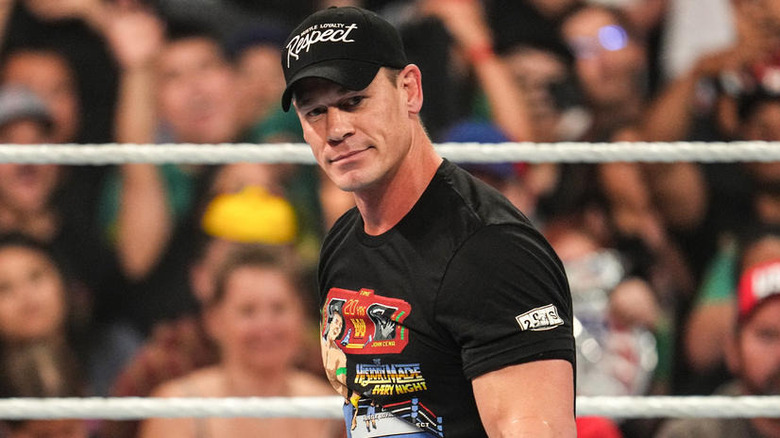 John Cena smiling in a WWE ring