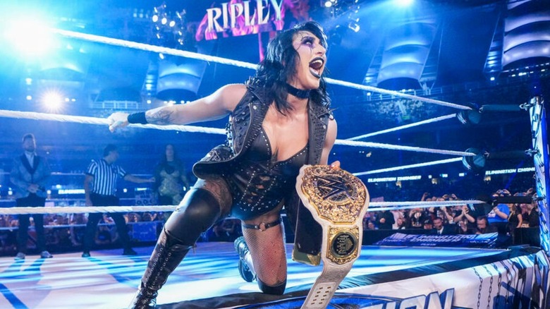 Rhea Ripley kneels on the ramp with the Women's World Championship before a match against Nia Jax at Elimination Chamber