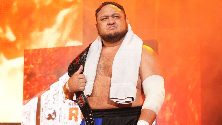 Samoa Joe holding championship belt