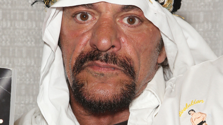 Sabu looking into camera