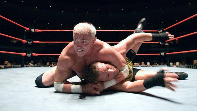 Bob Holly holding Rob Van Dam in a chokehold