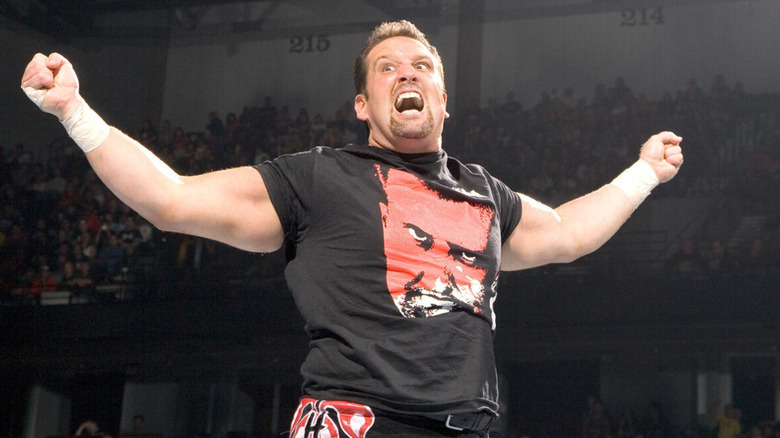 Tommy Dreamer posnig on the top turnbuckle