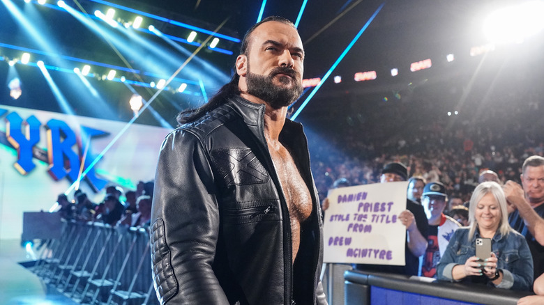 Drew McIntyre stands in front of a lot of blue lights