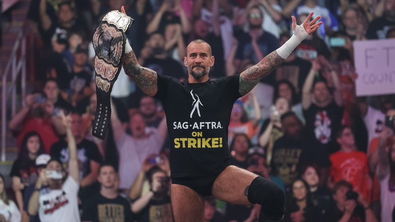 CM Punk posing with AEW World Championship