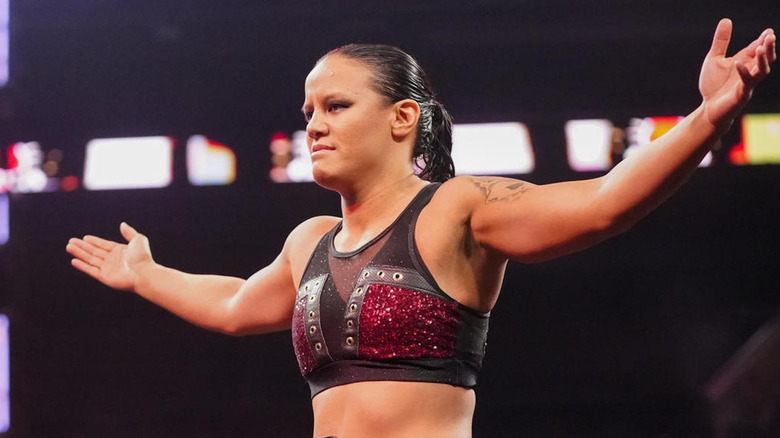 Shayna Baszler stanfing in wrestling ring with arms outstretched