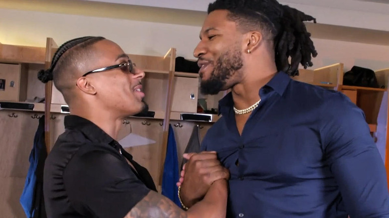 Carmelo Hayes and Trick Williams shaking hands backstage