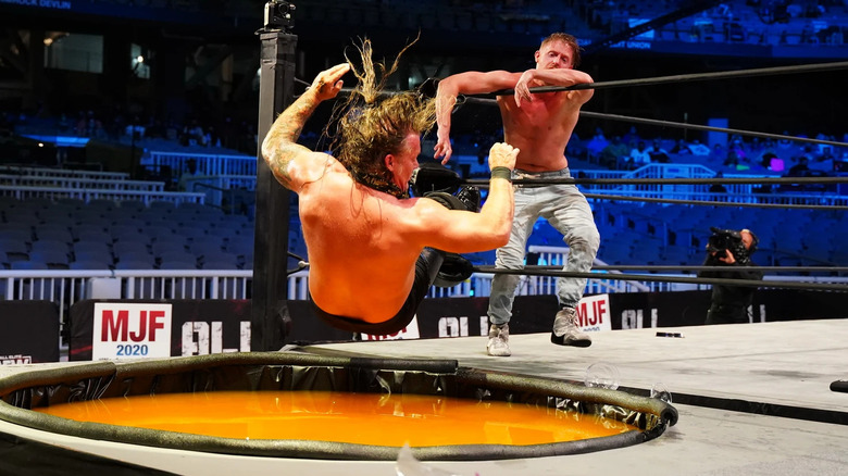 Orange Cassidy pushes Chris Jericho into a vat of mimosas at ringside during their Mimosa Mayhem Match at All Out 2020.