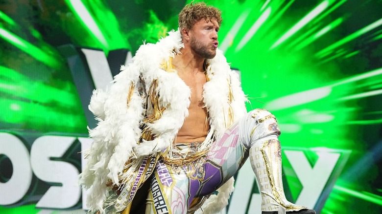 Will Ospreay pumps up his knee during his entrance.