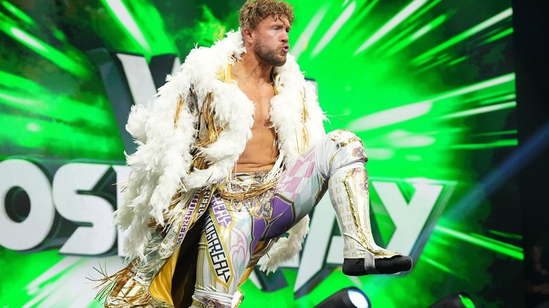 Will Ospreay pumps up his knee during his entrance.