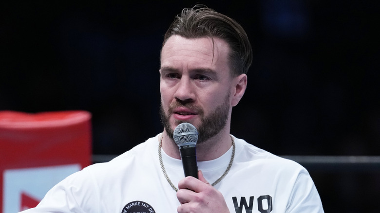 Will Ospreay speaking into a mic