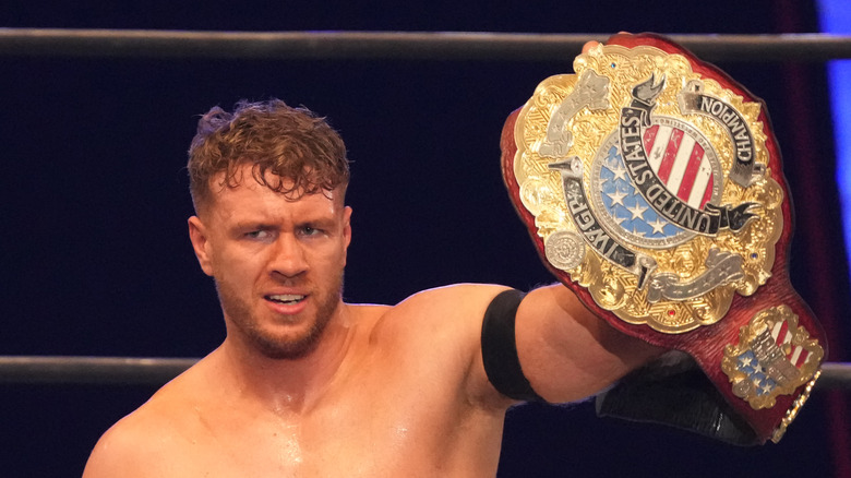 Will Ospreay holding up a championship