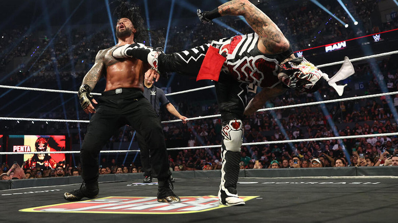 Penta delivers a superkick to Roman Reigns