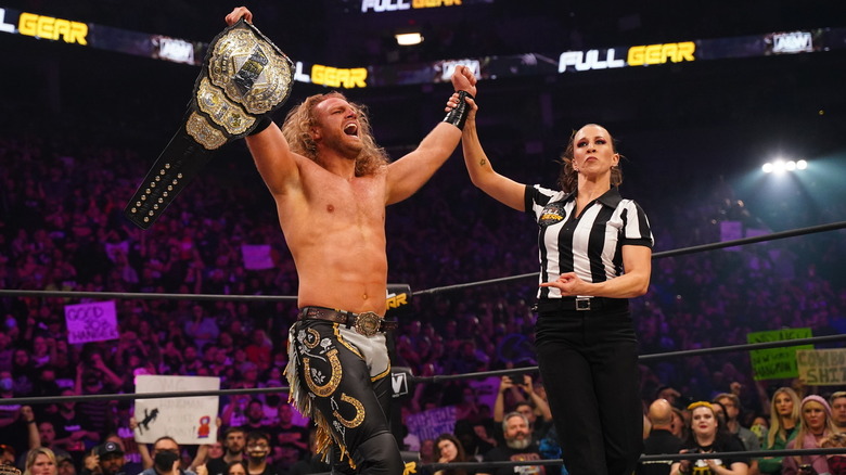 Aubrey Edwards raising Hangman Adam Page's arm after winning AEW World Championship